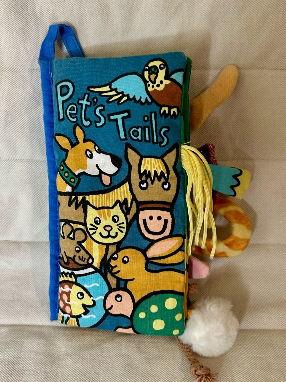 Jellycat Pets' Tails Soft Activity Book in Teal, Yellow and Brown